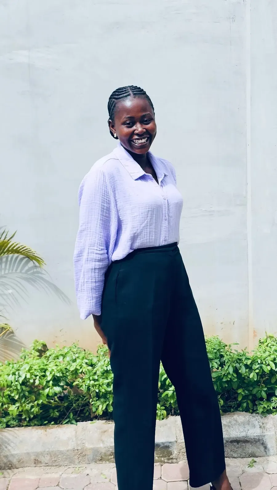 Jennifer Ibiba, founder of Biba's Treats, smiling outdoors in Abuja