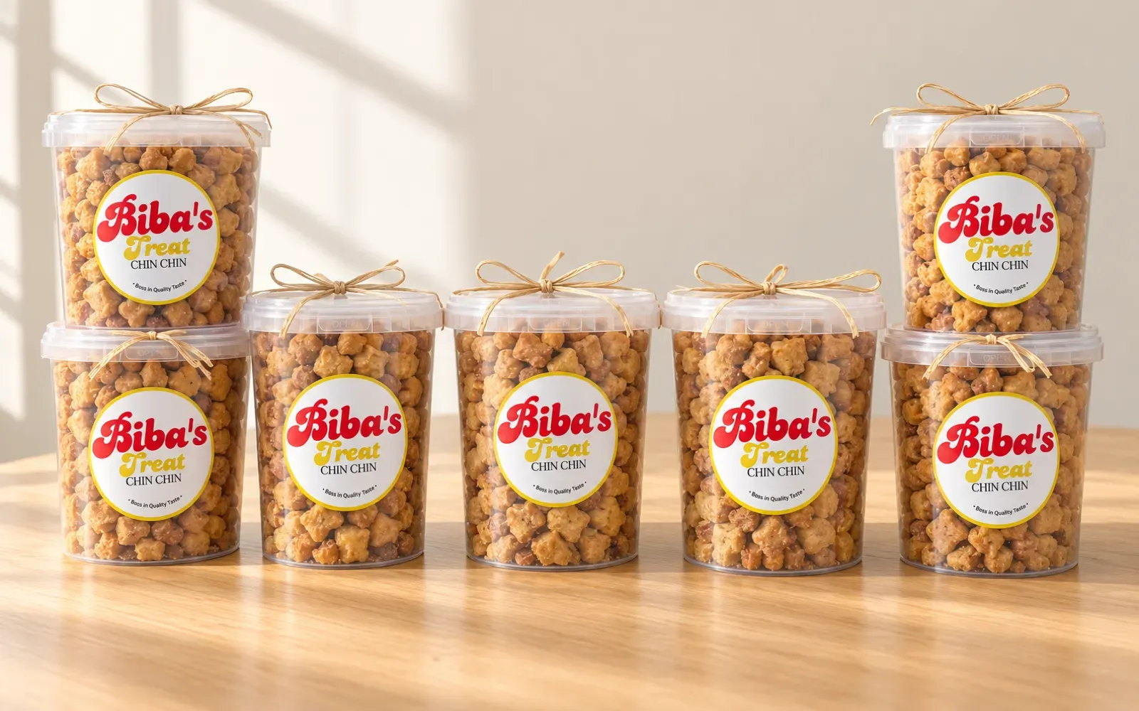 Tubs of Biba's Treats chinchin tied with ribbon, lined up on a table for a handout