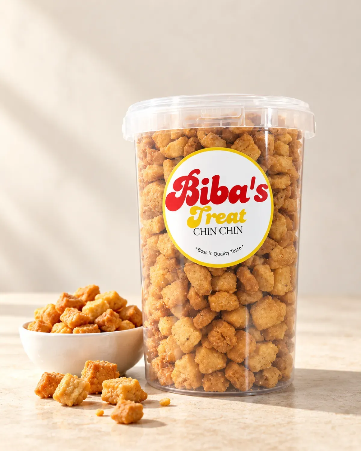 A clear tub of Biba's Treats chinchin with its round red and gold sticker